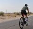 Cyclist using a bike radar taillight on a road in Oman